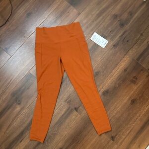 Athleta Salutation stash pocket leggings 7/8 inch burnt orange